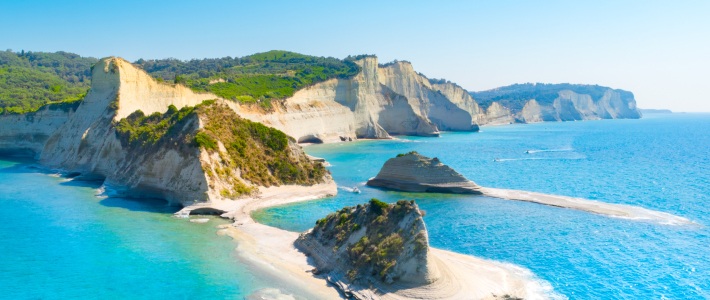 Acantilados blancos y aguas turquesas en la costa de Corfú con pequeñas islas rocosas en el Cabo Drastis, Corfúr