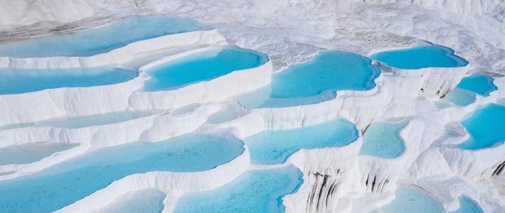 Piscinas naturales de Pamukkale con agua azul sobre formaciones blancas