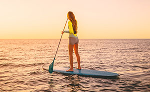 Chica haciendo paddle surf